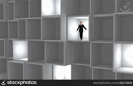 Office life. Miniature of businessman walking in white cube