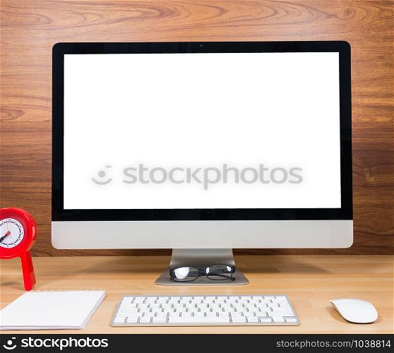 Office monitor computer, mouse on wood table and wooden wall background