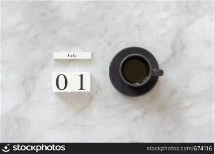 Office or home table desk. Wooden cubes calendar July 1st and cup of coffee on marble background Concept stylish workplace Flat lay Top view Minimal style.. Office or home table desk. Wooden cubes calendar July 1st and cup of coffee on marble background Concept stylish workplace Flat lay Top view Minimal style