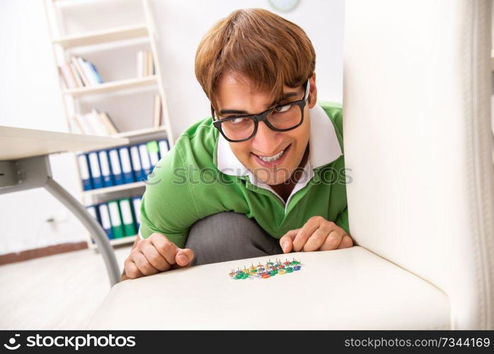 Office prank with sharp thumbtacks on chair