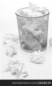 Office silver trash bin full of paper waste white isolated