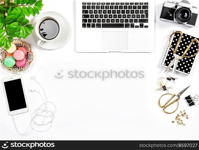 Office supplies and laptop. Feminine flat lay. Coffee and macaroon cookies