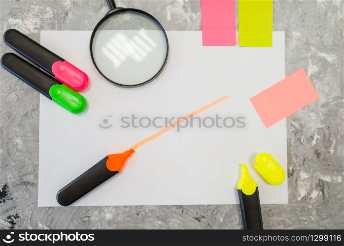 Office supplies, magnifier and colorful markers on the table in stationery store, nobody. Assortment in shop, accessories for drawing and writing, school equipment. Magnifier and colorful markers in stationery store