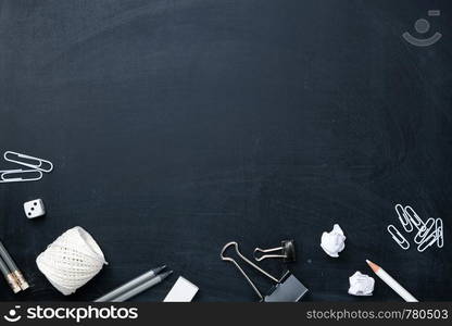 Office supplies on blackboard. Back to school concept background. Copy space. Top view. Flat lay