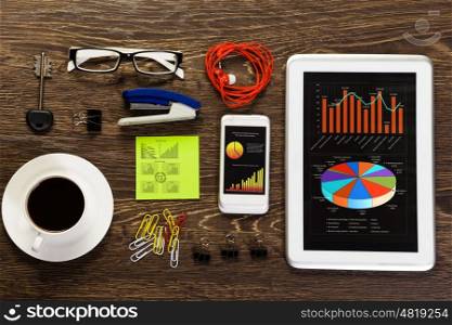Office table. Office workplace with tablet cup mobile phone and stationary