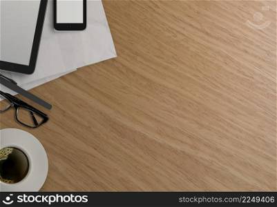 Office table with tablet computer,mobile phone and coffee cup on wooden background
