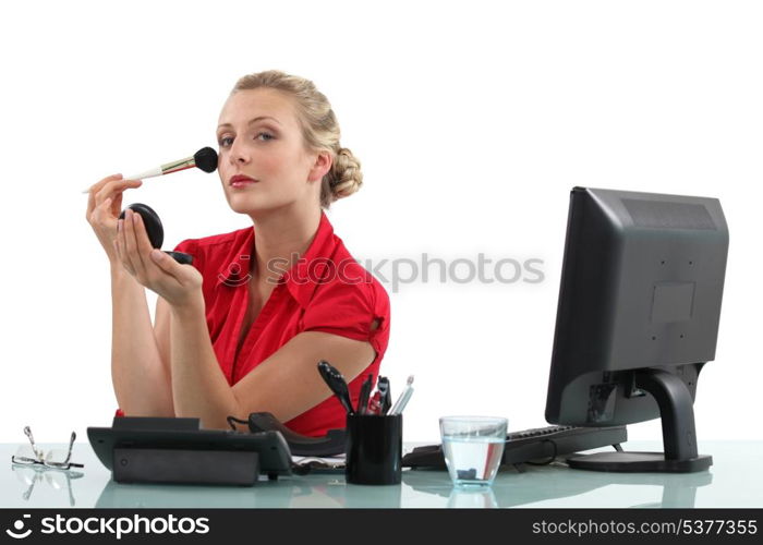 Office worker applying blusher