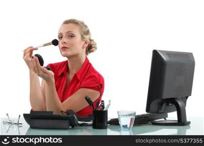Office worker applying blusher