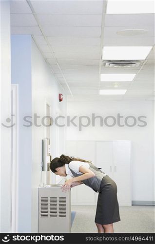 Office worker at water fountain