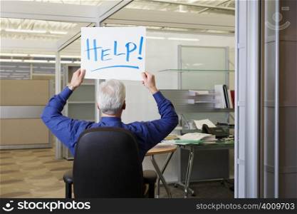 Office worker holding a help sign