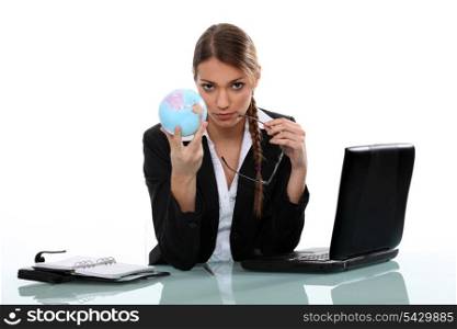 Office worker holding globe