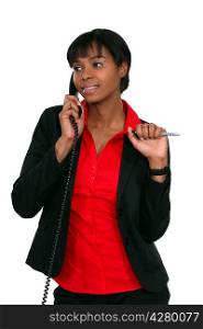 Office worker holding pen during phone call