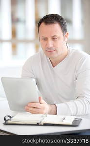 Office worker in the office using electronic tab