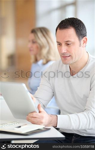 Office worker in the office using electronic tab