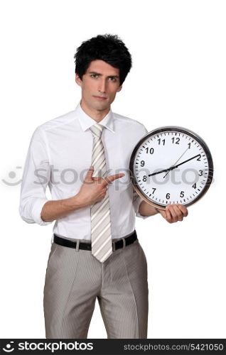 Office worker pointing his finger to a clock
