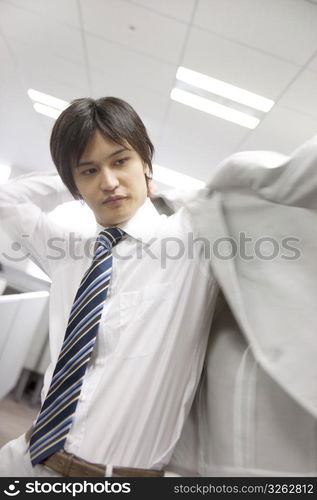 Office worker putting on a jacket