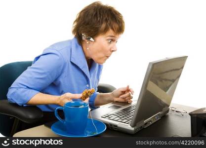 Office worker snacking and browsing the internet, shocked by what she&rsquo;s seeing. Isolated on white.
