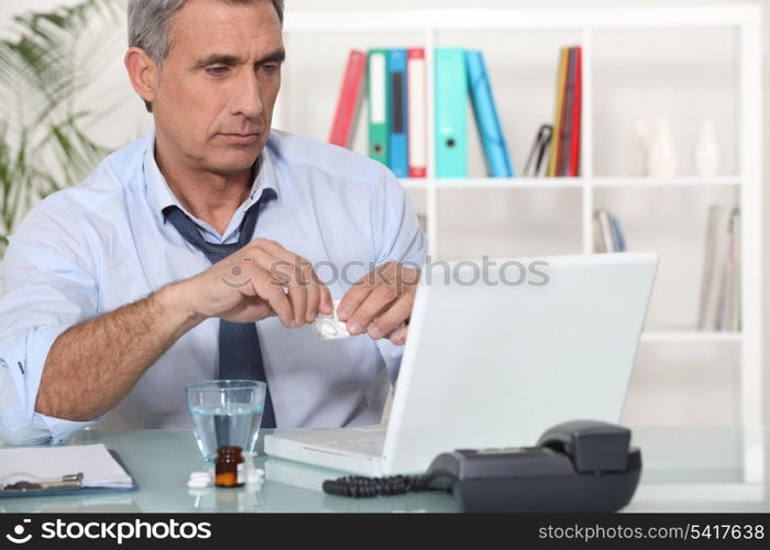 Office worker taking medication