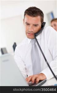 Office worker talking on the phone in office