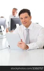 Office worker using electronic tablet in office
