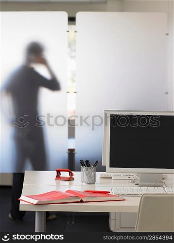 Office Worker Using Telephone Behind Partition