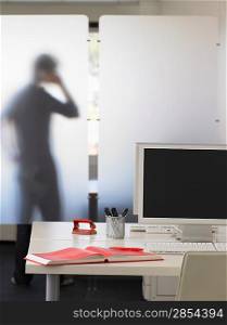 Office Worker Using Telephone Behind Partition