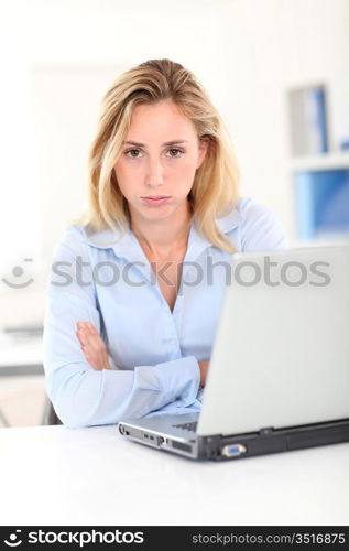 Office worker with bored look on her face