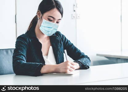 Office worker with face mask quarantine from coronavirus or COVID-19. Concept of protective working environment to reopen business and stop spreading of coronavirus or COVID-19.