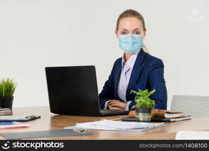 Office worker with face mask quarantine from coronavirus or COVID-19. Concept of protective working environment to reopen business and stop spreading of coronavirus or COVID-19.