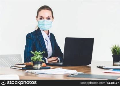 Office worker with face mask quarantine from coronavirus or COVID-19. Concept of protective working environment to reopen business and stop spreading of coronavirus or COVID-19.