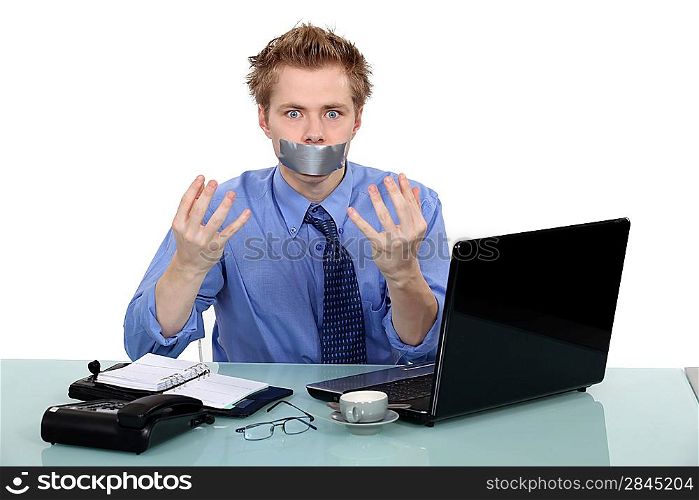 Office worker with his mouth taped shut