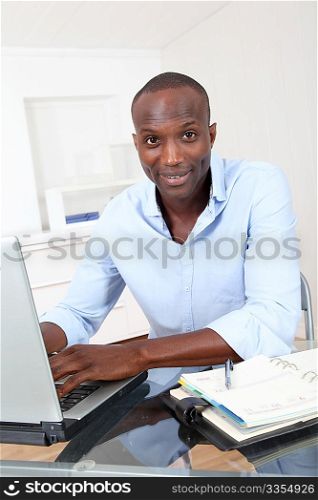 Office worker working on laptop computer