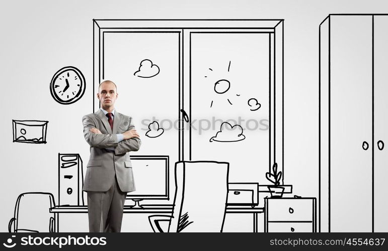 Office worker. Young confident businessman standing in drawn office