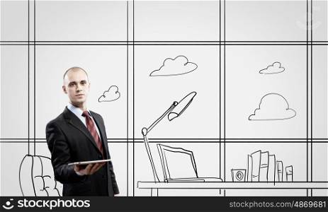 Office worker. Young confident businessman standing in drawn office