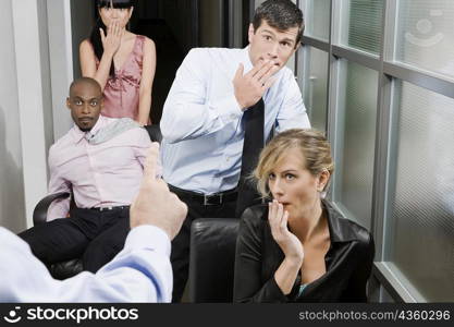 Office workers being scolded by their boss