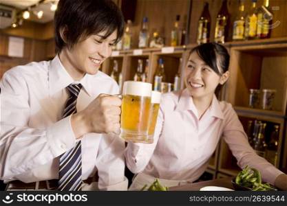 Office workers enjoy drinking a beer