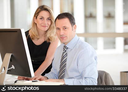 Office workers in front of computer