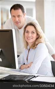Office workers in front of desktop computer