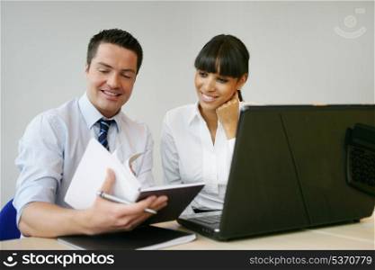 Office workers in front of laptop