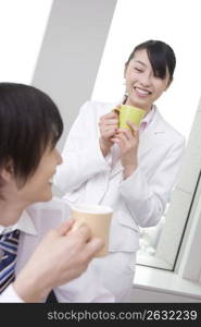 Office workers taking a break with drinking a coffee