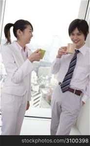Office workers taking a break with drinking a coffee