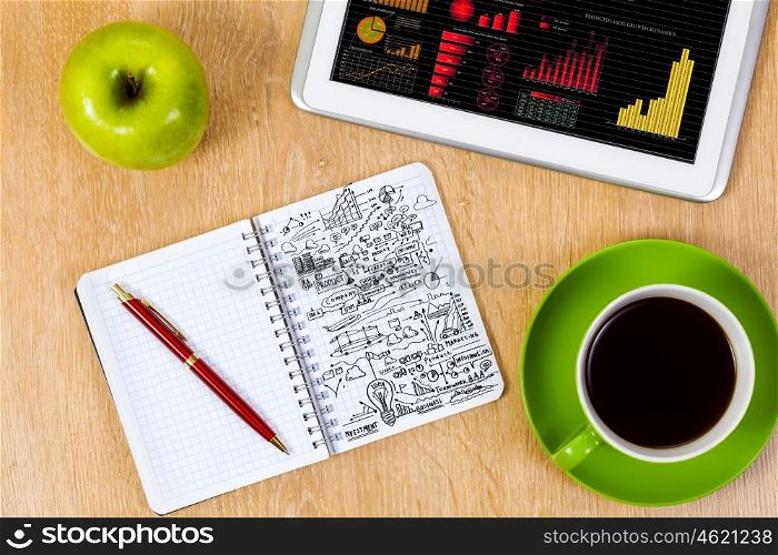 Office workplace. Close up image of tablet pc apple cup of coffee on table