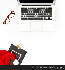 Office workplace. Flat lay Christmas decoration. Notebook and glasses on white background