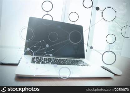 Office workplace with laptop and smart phone on wood table with social media diagram