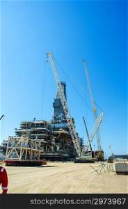 Offshore drilling during construction onshore