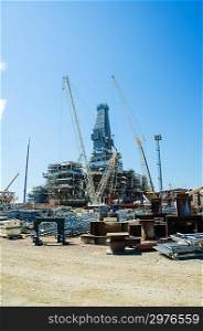 Offshore drilling during construction onshore