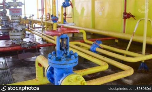 Offshore gas and oil production platform series of pipes, gauges and valves in the East-Kazantip field, pan shot