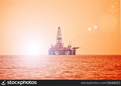 Offshore oil rig during sunset in Caspian sea