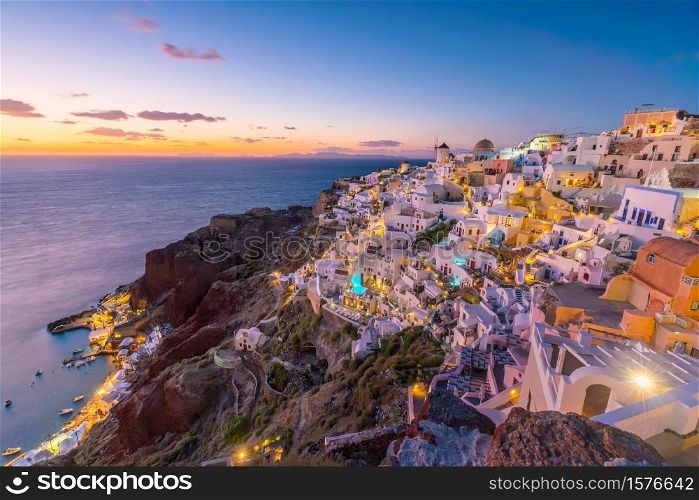 Oia town cityscape at Santorini island in Greece at sunset. Aegean sea