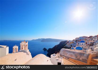 Oia town on Santorini island, Greece. Traditional and famous houses and churches with blue domes over the Caldera, Aegean sea. Wide angle view